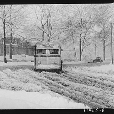 Bus going through the snow near Connecticut Avenue and Chevy Chase Circle