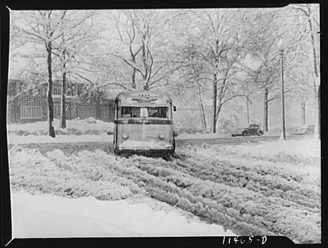 Bus going through the snow near Connecticut Avenue and Chevy Chase Circle