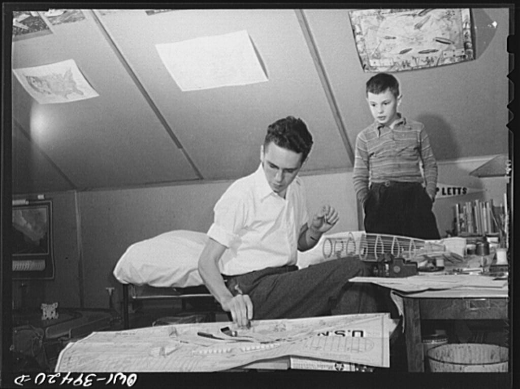 Walter Spangenberg, a student at Woodrow Wilson High School, with his nine year-old brother as he works on a model airplane at home (Library of Congress)