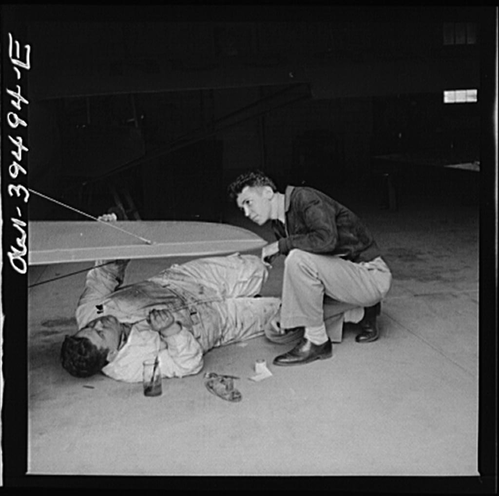 Frederick, Maryland. Walter Spangenberg, a student at Woodrow Wilson High School, watches a mechanic repairing a plane at the Stevens Airport (Library of Congress)