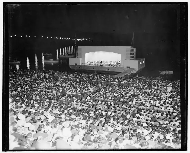 Washington turns out for open air music. Washington, D.C., July 12, 1939. Sitting on stone steps near the Lincoln Memorial here, and facing a barge moored in the Potomac River, thousands of Washingtonians turned out to listen to the first of a series of summer concerts by the Washington Symphony Orchestra under the direction of Dr. Hans Kindler tonight. To give it his blessing and to enjoy the music, President Roosevelt arrived shortly before intermission accompanied by Brig. Genl. Edwin M. Watson, military aide, and Mrs. Watson (Library of Congress)