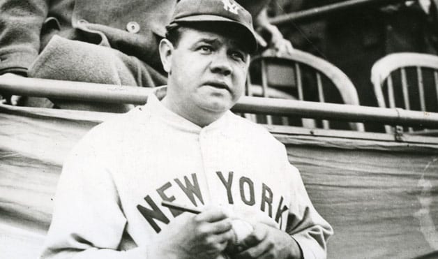 Babe Ruth signing a baseball in an undated photo