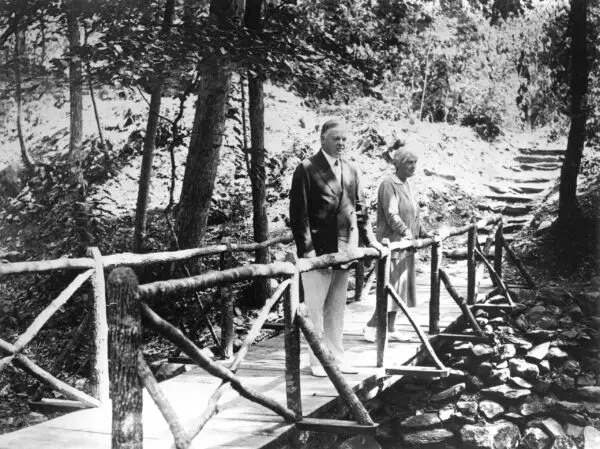 Herbert and Lou Hoover on footbridge at Rapidan Camp