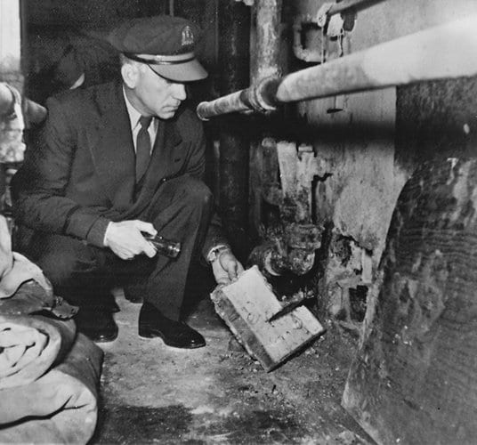 prison guard inspects the hole into the service corridor