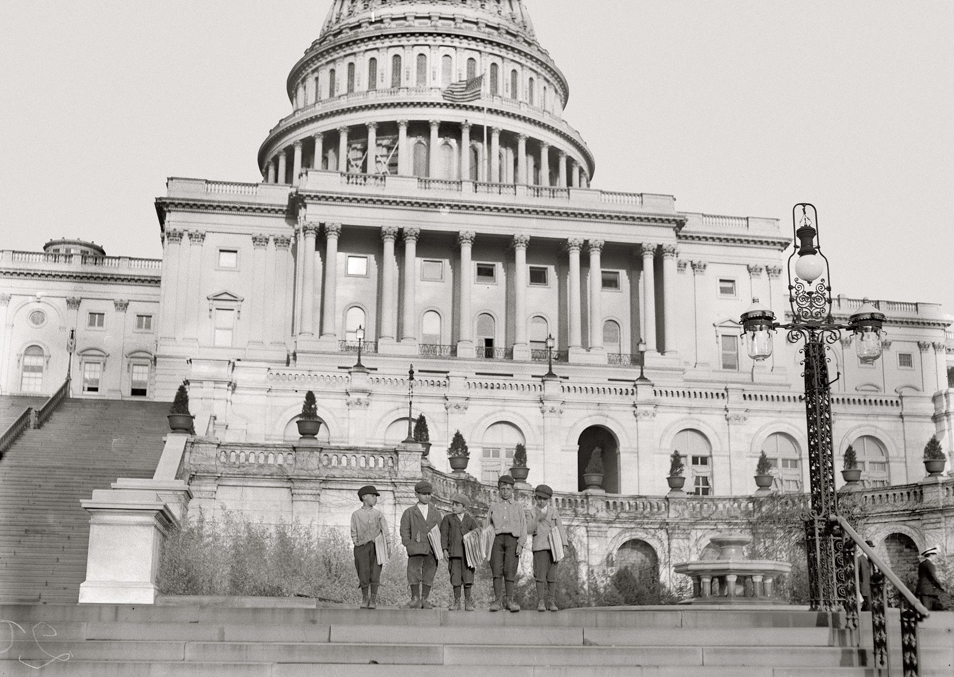 April 11, 1912. Washington, D.C. "Group of newsies selling on Capitol steps. Tony Passaro, 8 yrs. old, 124 Schottes Alley N.E.; Dan Mercurio, 9 yrs. old, a chronic truant, 150 Schottes Alley; said he made 8 cents to-day. Joseph Tucci, 10 years old, 411½ 5th St. N.E.; Peter Pepe, 10 yrs. old, 24 Wonders Court; John Carlino, 11 yrs. old." Photograph and caption by Lewis Wickes Hine.