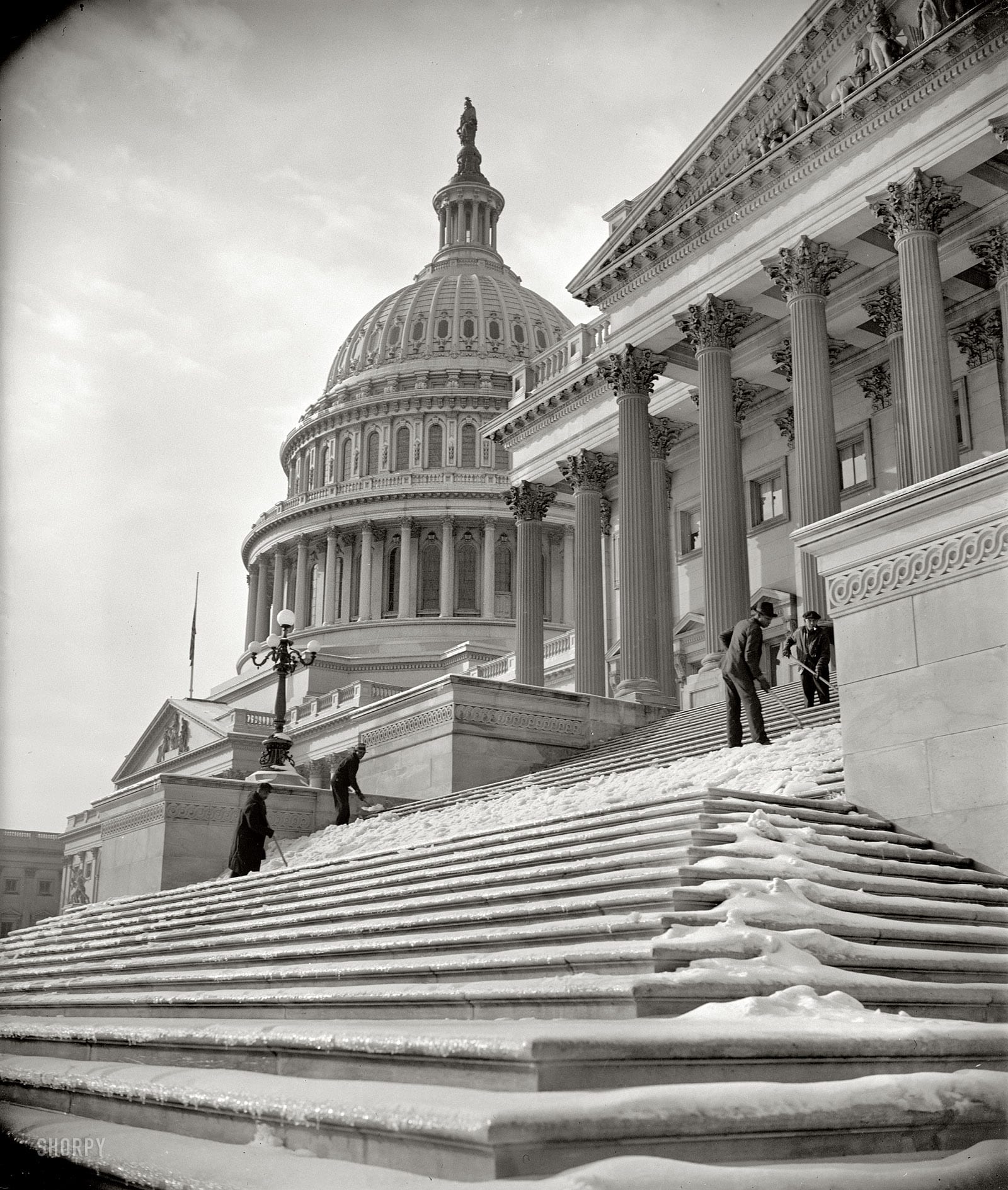 January 14, 1939. "National Capital digs out after storm. Nearly five inches of snow blanketed Washington yesterday, followed by sleet. Icy steps made the going to and from the Capitol difficult until workmen arrived this morning and scraped away the menace." Harris & Ewing Collection glass negative