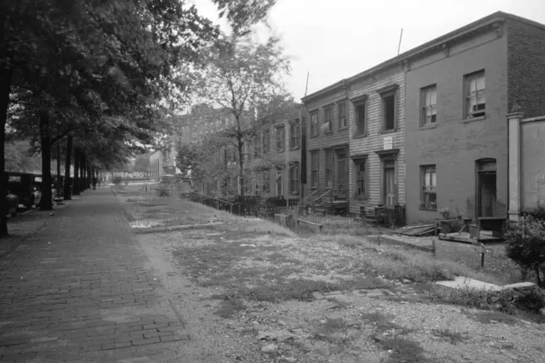 Section of Massachusetts Avenue showing block of shabby houses with outside toilets and water supply