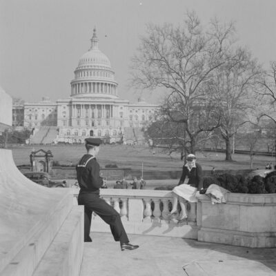 Washington, D.C. Sailor taking a picture of his girlfriend at a monument in front of the Capitol on a Sunday afternoon