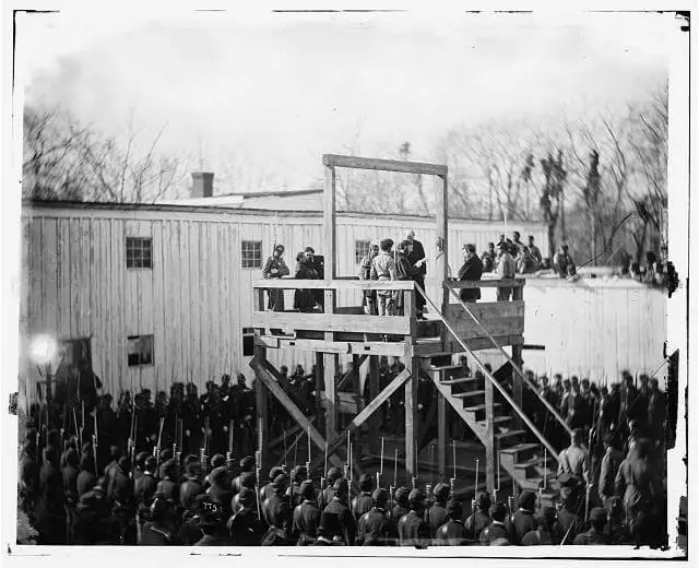 a death warrant being read to inmate Wirz on the gallows