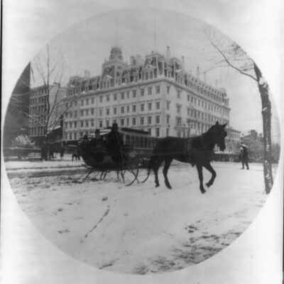 Photo shows a horse-drawn sleigh carrying what may be Melinda and Elise Painter across 14th St. at F St. in front of the Ebbitt House hotel. The modest buildings to the right of the grand hotel housed Newspaper Row, and just across the street at number 501 was Painter's office as Washington correspondent for the Philadelphia Inquirer. (Source: Ison article on Painter, 1990)