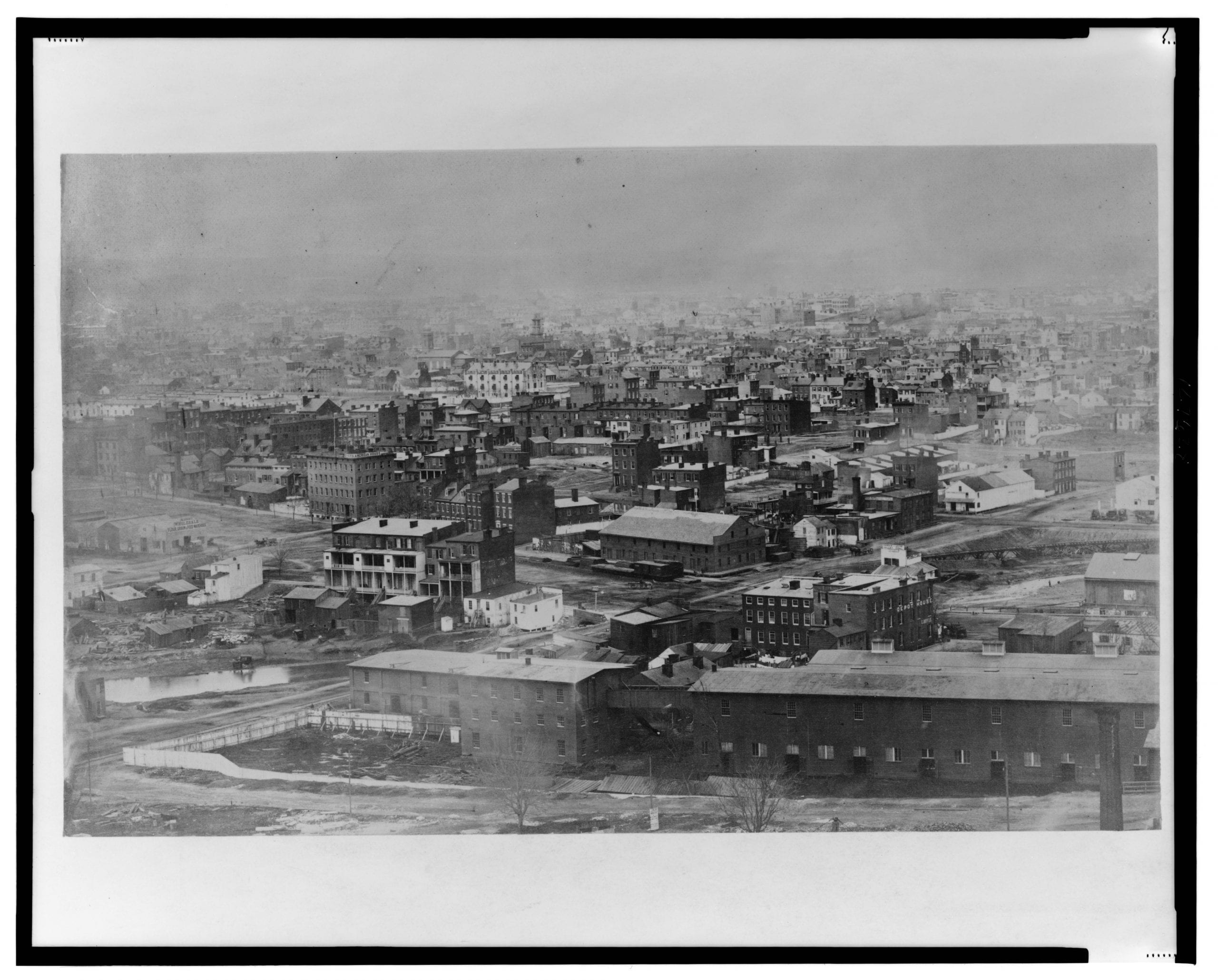 Northwest view with 1st, B, C, D streets, and Indiana Ave. in the foreground; view includes the Washington Jail, Aldrich's Wholesale Flour, Grain & Feed Warehouse, Dyers American House, Shamokin & Lykins Valley Coal (Wood & Coal), Depot House, C. Boyle, and Door, Sash & Blind Factory.