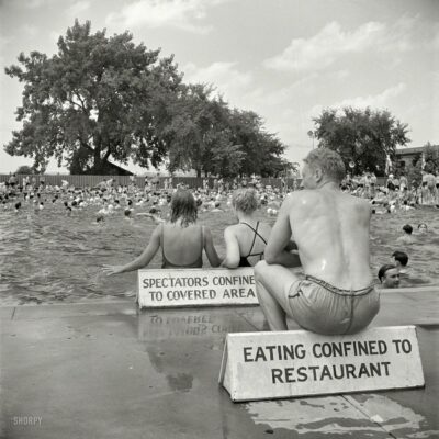 July 1942. Washington, D.C. "Municipal swimming pool on Sunday." Remember: Sitting confined to sign. Photo by Marjory Collins for the OWI.
