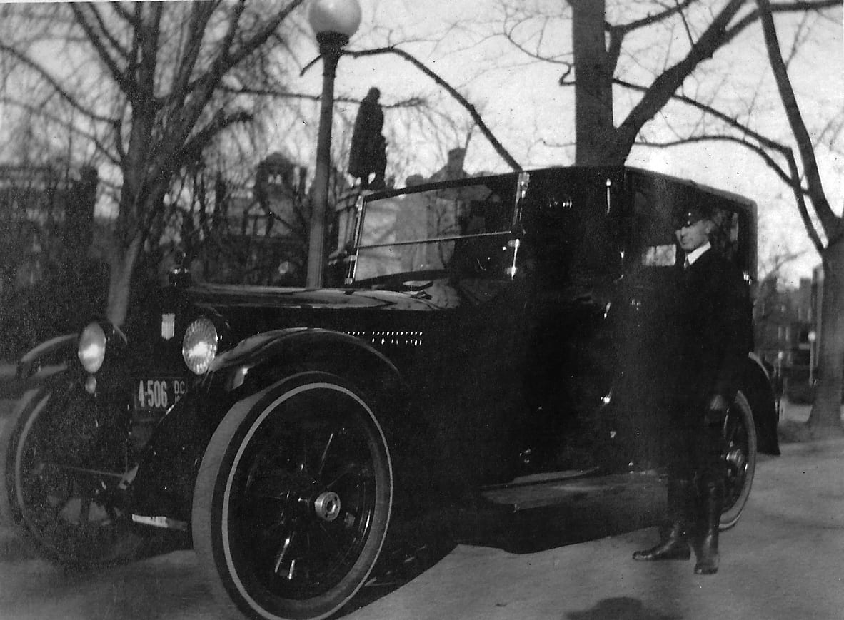 chauffeur in front of car