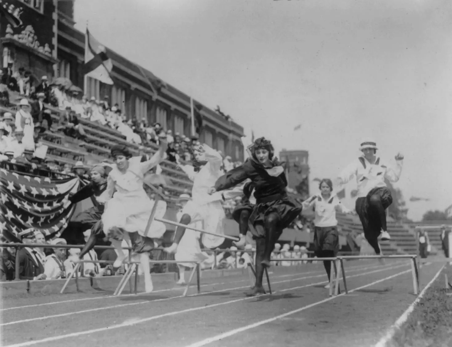 Women competing in low hurdle race