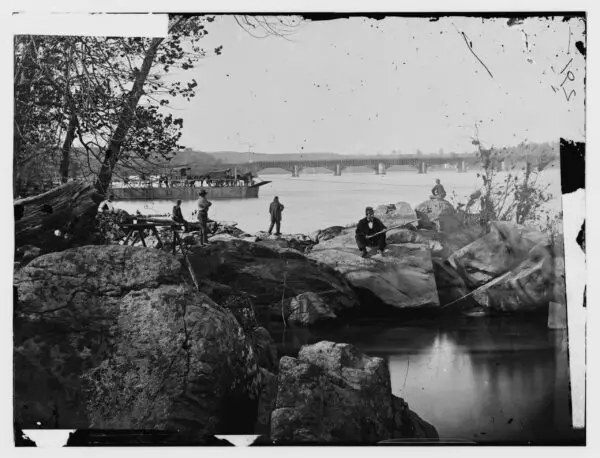 Washington, D.C. Georgetown ferry-boat carrying wagons, and Aqueduct Bridge beyond, from rocks on Mason's Island (Library of Congress)
