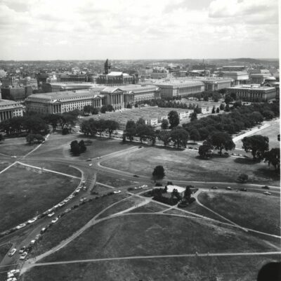 Aerial view from the Washington Monument showing the "Tempos" or temporary buildings before their demolition. They were located on the site of the future National Museum of History and Technology (NMHT), now the National Museum of American History (NMAH)