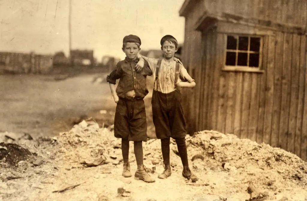Two young carrying-in boys in Alexandria (Va.) Glass Factory. Frank Clark (on left) 702 N. Patrick St., could neither read nor write, having been to school only a few weeks in his life. Two older brothers work in glass factory, and his father is a candy maker. Frank is working on night shift this week. Ashby Corbin (on right), 413 N. St. Asaph St. Has had only four terms of schooling. See also photos and labels 2260 to 2271. Location: Alexandria, Virginia.