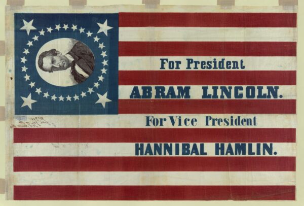 Print shows a large campaign banner for Republican presidential candidate Abraham Lincoln and running mate Hannibal Hamlin. Lincoln's first name is given here as "Abram." The banner consists of a thirty-three star American flag pattern printed on cloth. In one corner, a bust portrait of Lincoln, without beard, encircled by stars, appears on a blue field.