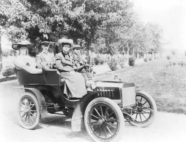 Frances Benjamin Johnston seated with three other people in automobile