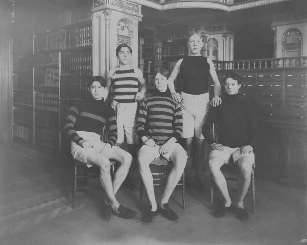 Members of Georgetown University’s track team, complete with running shoes, pose somewhat incongruously in front of the card catalog in Riggs Library