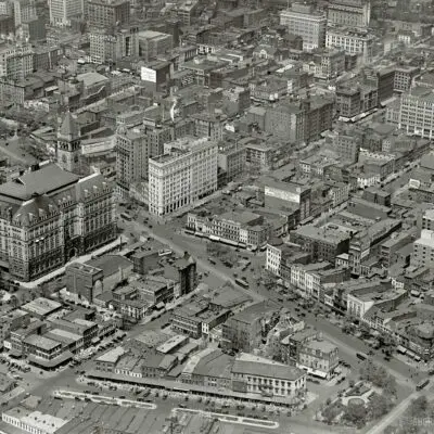 Washington, D.C., circa 1922. "Star Building from air." The Washington Star newspaper building at the center is at the intersection of 11th Street N.W. and Pennsylvania Avenue, which runs diagonally across the photo. The big building with the tower us the Old Post Office. There's a lot to see here, including laundry hung out to dry. National Photo Company glass negative.