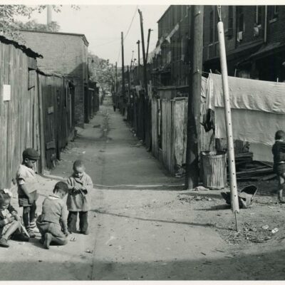 Children playing in the Defrees Alley, NE Washington, D.C.; Near Capitol Building; One basement room rents for $9.00 a month, two rooms upstairs for $ 16.00, one bath and cold water in the hall for entire building.. Wolcott, Marion Post -- Photographer