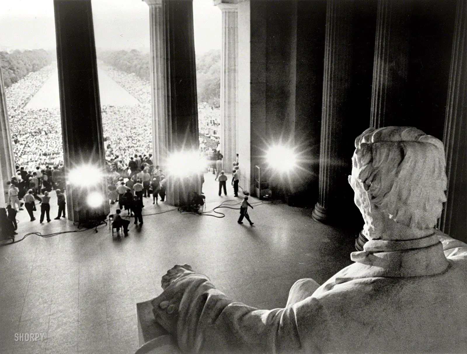 August 28, 1963. "Emancipator looking down on demonstrators. Participants in the March on Washington in front of the Lincoln Memorial and massed along both sides of the Reflecting Pool, viewed from behind Abraham Lincoln statue." Photo by James K. Atherton for United Press International.