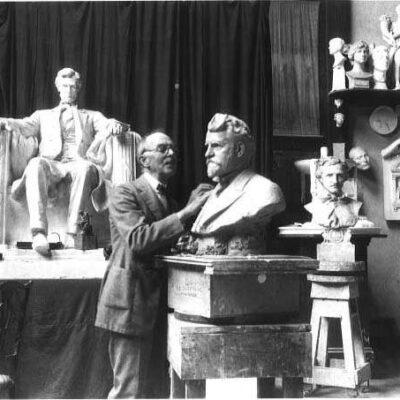 Picture of Daniel Chester French in his studio with Lincoln Memorial statue in the background
