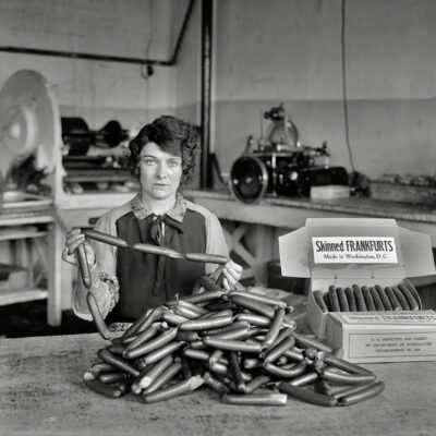 1927. "Skinned frankfurts, made in Washington, D.C." What Bismarck said about laws and sausages: It turns out you can watch them (or not watch them) being made in the same place. Harris & Ewing glass negative.