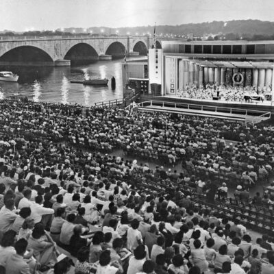 Crowd on Watergate steps watching performance on barge at edge of Potomac River (ca. 1956). Burdell Wright, Jr. Photograph Collection