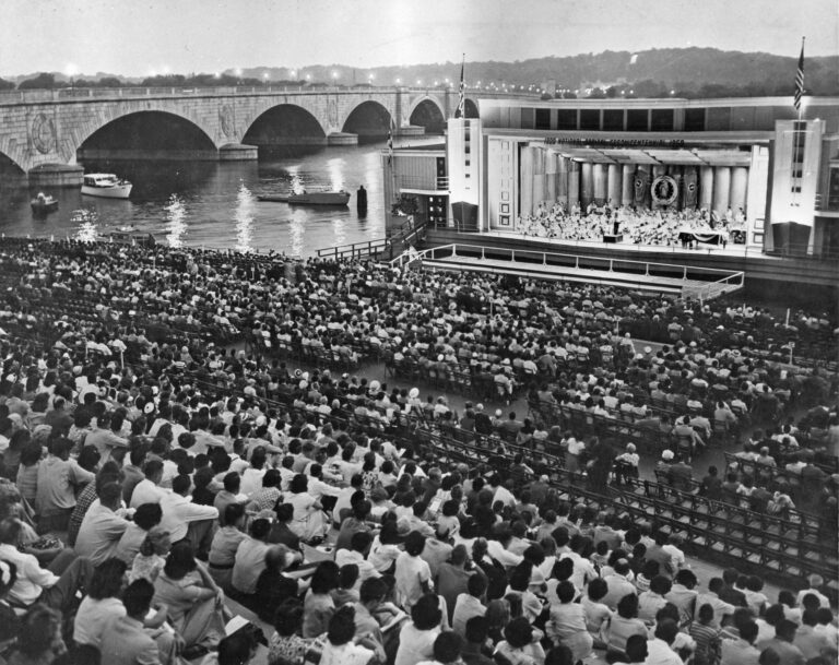 Crowd on Watergate steps watching performance on barge at edge of Potomac River (ca. 1956). Burdell Wright, Jr. Photograph Collection