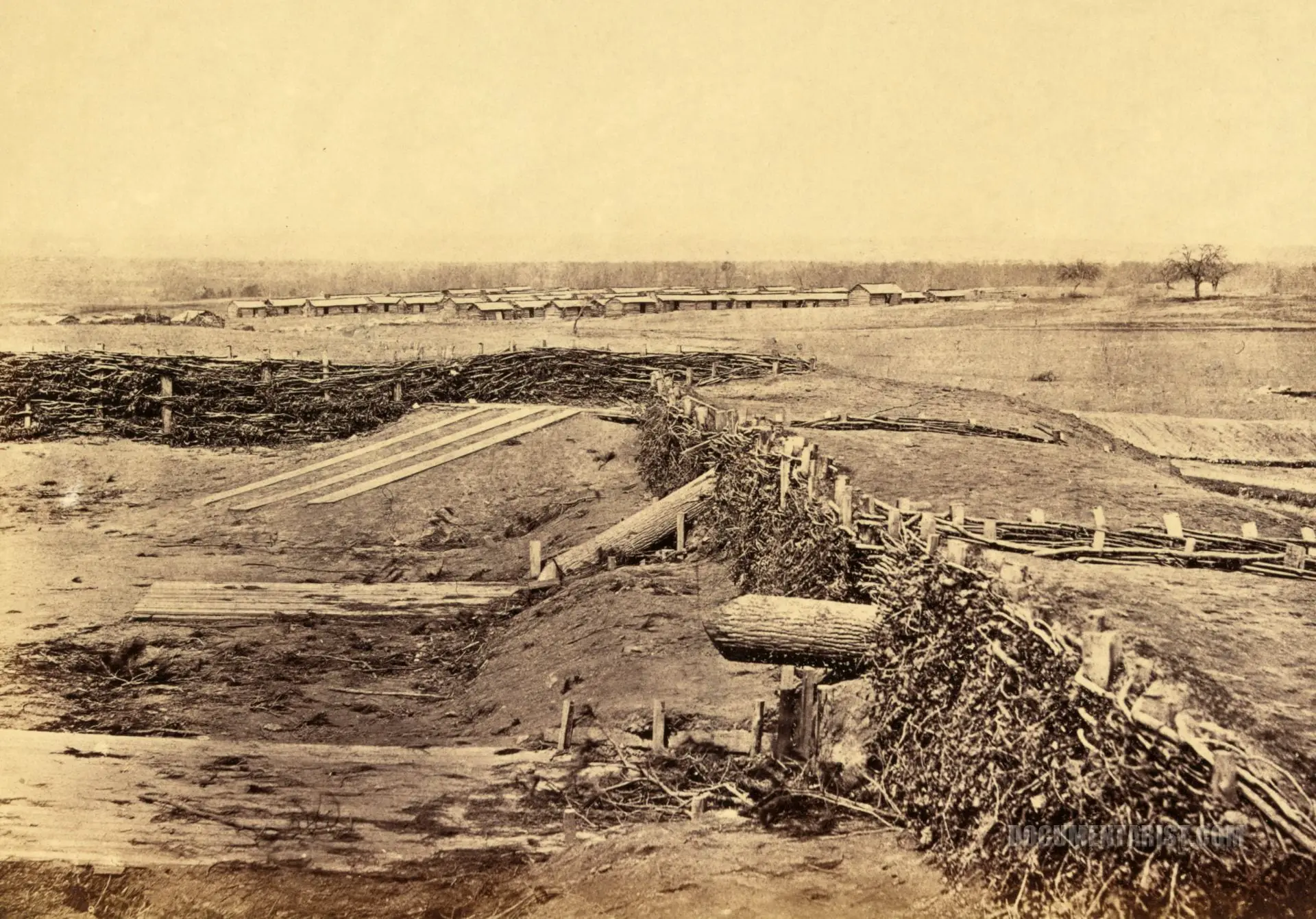 Confederate fortifications at Centreville, Va. March 1862. Quaker guns in foreground. Winter barracks in background.