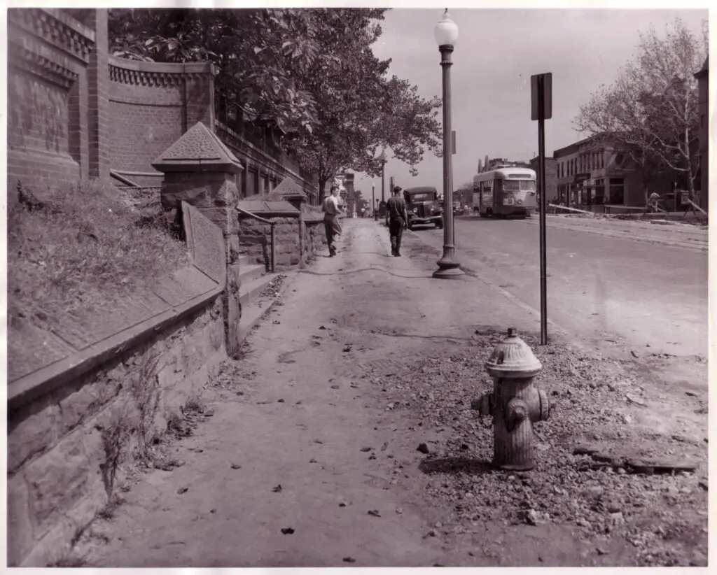 At 3rd & H Streets, NE, a streetcar passes an unpaved sidewalk and no-longer existing wall, September 1947