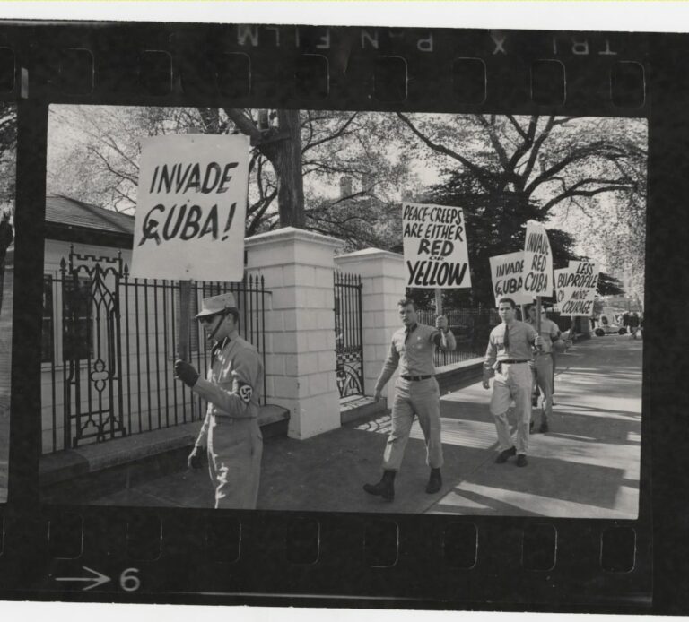 Demonstrators from a broad political spectrum picket outside the White House during the height of the Cold War confrontation between the United States and the Soviet Union over the placement of missile silos in Cuba. The Cuban missile crisis demonstration attracted elements on the fringe of American society as evidenced by the last panel frame showing members of an American neo-Nazi group protesting President John F. Kennedy’s “soft” stance on Cuba.