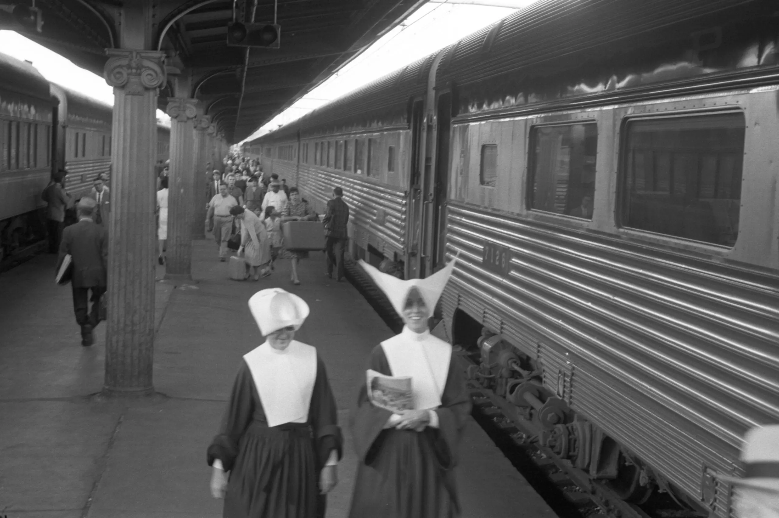 Passengers including nuns walking near trains, Union Station, Washington, D.C.