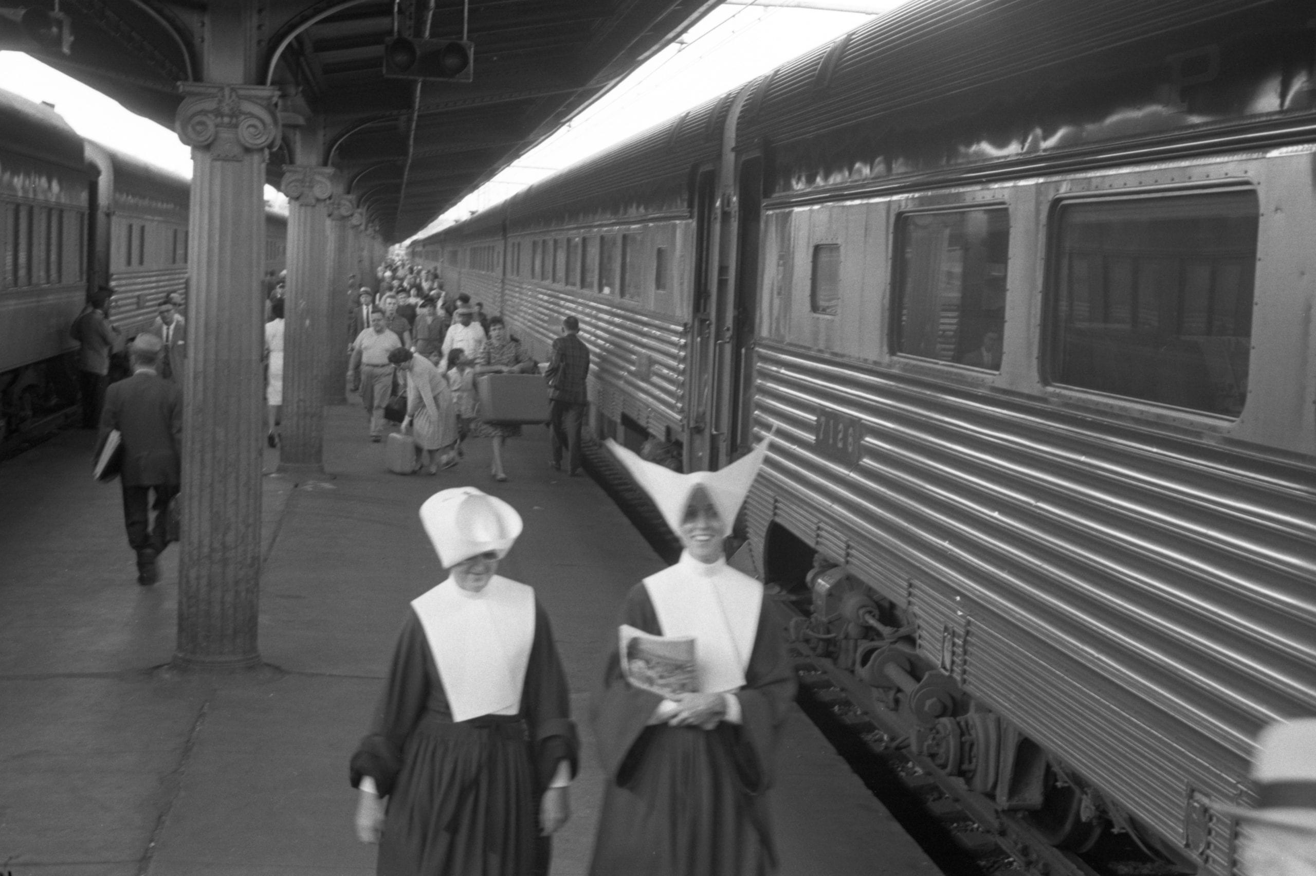 Passengers including nuns walking near trains, Union Station, Washington, D.C.