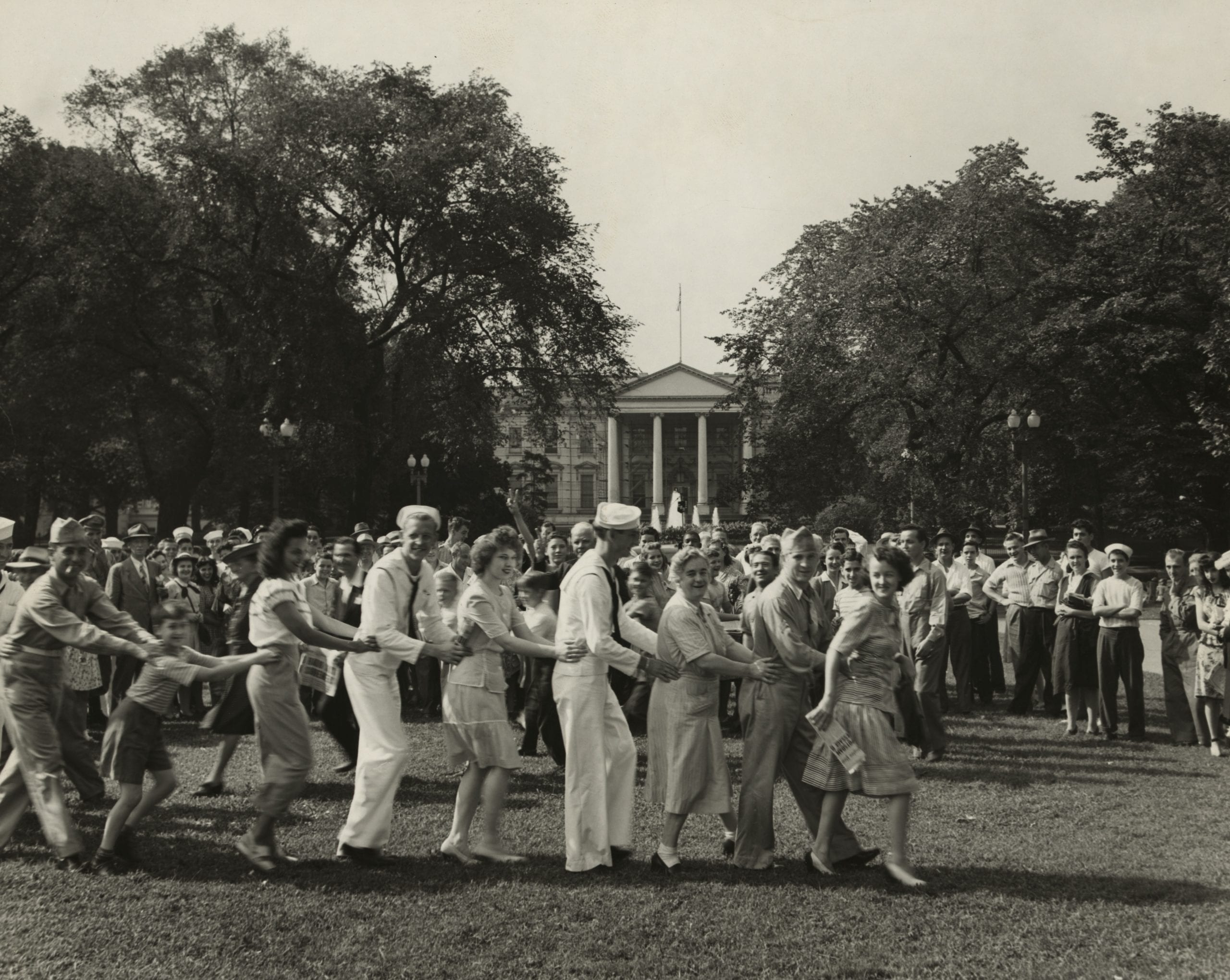 Jubilant crowd on V-J day dancing on the White House lawn