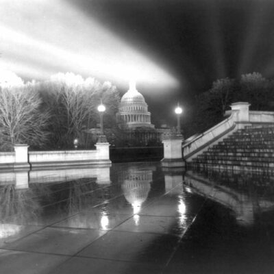 Night view in rain [of Capitol] taken from steps [Neptune Plaza] of Library of Congress