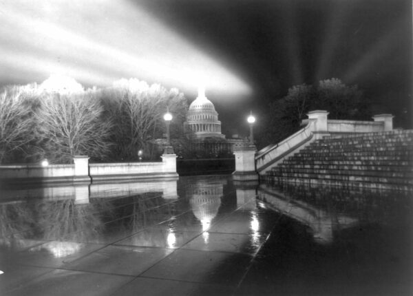 Night view in rain [of Capitol] taken from steps [Neptune Plaza] of Library of Congress