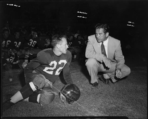 Charlie "Choo Choo" Justice on sidelines with Washington Redskins head coach Joe Kuharich during game versus the Green Bay Packers at Riddick Stadium, Raleigh, N.C., September 11, 1954 