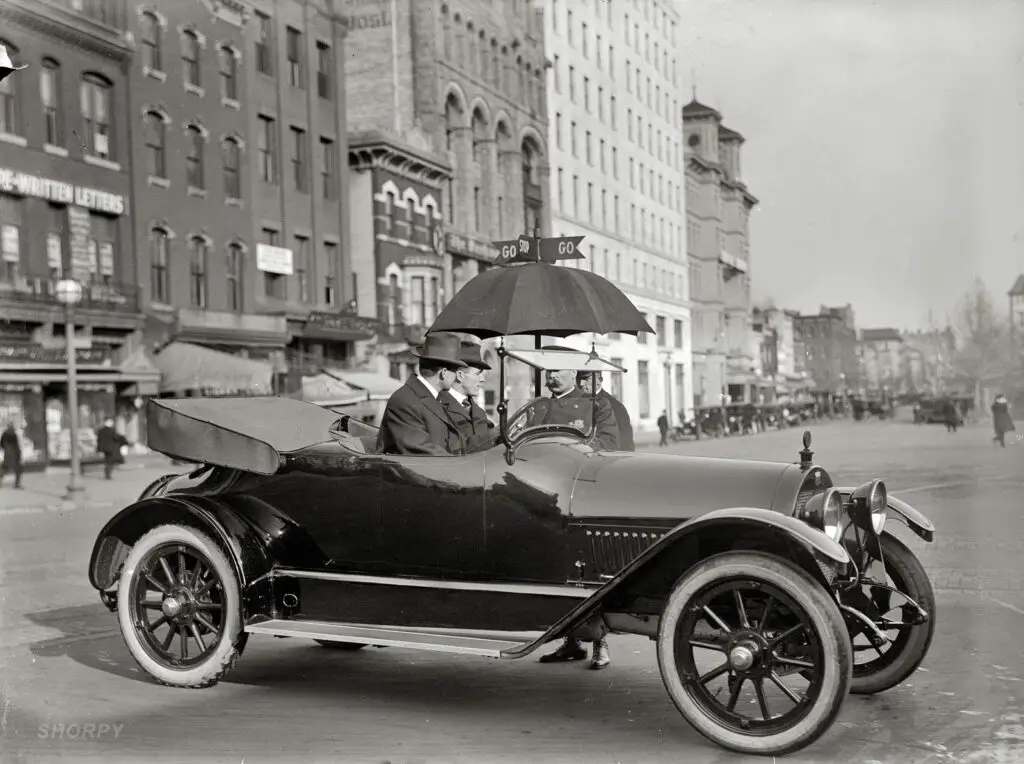 1913. "District of Columbia traffic. Stop and Go signs." A very new-looking circa 1913 Haynes roadster in Washington crossing Pennsylvania Avenue at 14th Street N.W. Harris & Ewing Collection glass negative.