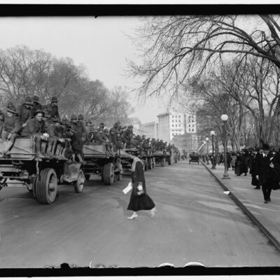 soldiers rolling through Washington on trucks