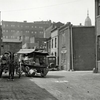 Produce wagon in city, 1923." One in a series of Harris & Ewing plates showing the alleys and backstreets of Washington, D.C. The subject here is a Chaconas grocery wagon