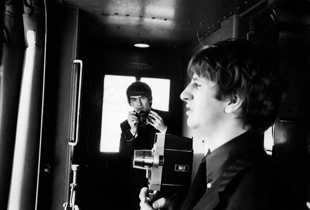 George Harrison takes a photo of Ringo Starr on the train to DC