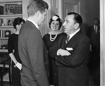 Thomas D’Alesandro Jr., former mayor of Baltimore, talks on March 28, 1961, at the White House with President John Kennedy after taking the oath to become a member of the Federal Renegotiation Board. Mrs. D’Alesandro and their daughter, Nancy (left), are in the background.