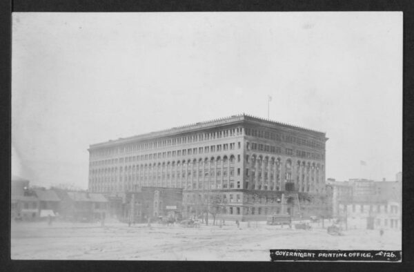 Long-distance view of the Government Printing Office on the northwest corner of North Capitol and G Streets NW showing structures in the 600 block of North Capitol and a streetcar heading south on North Capitol.