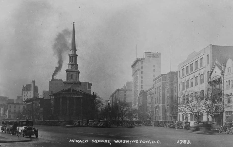 View looking west on New York Avenue NW from 13th Street and taking in the New York Avenue Presbyterian Church and the commercial buildings on H Street NW between 13th and 14th Streets. The time on the church steeple clock is 10:55 a.m.