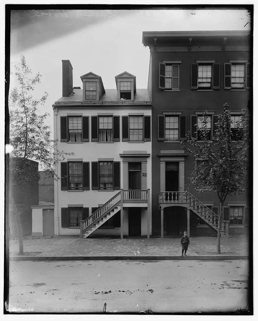 A picture of the Surratt house in 1890. The second story and first story entrances are still visible, though that would change in the next twenty years.