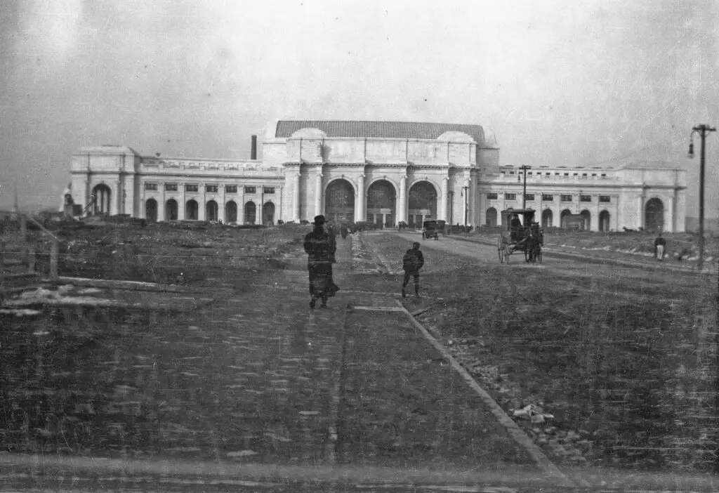 Taken by Sidney Duff in Washington, DC. Union Station was completed in October 1908. Here, only one of the six statues have been installed over the entrance. Another photo from the set shows the Tidal Basin frozen over, causing me to guess that this is January 1908.