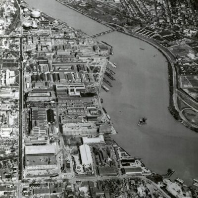 Aerial view of the Washington Navy Yard, looking east (top). This shot shows the Navy Yard’s borders: M Street on the north (left); the waterfront on the south; 11th street on the east, and 2nd street on the west (foreground). On the right bank of the river is Anacostia, September 1963. NHHC Photograph Collection, Navy Subject Files, Washington Navy Yard. (214).